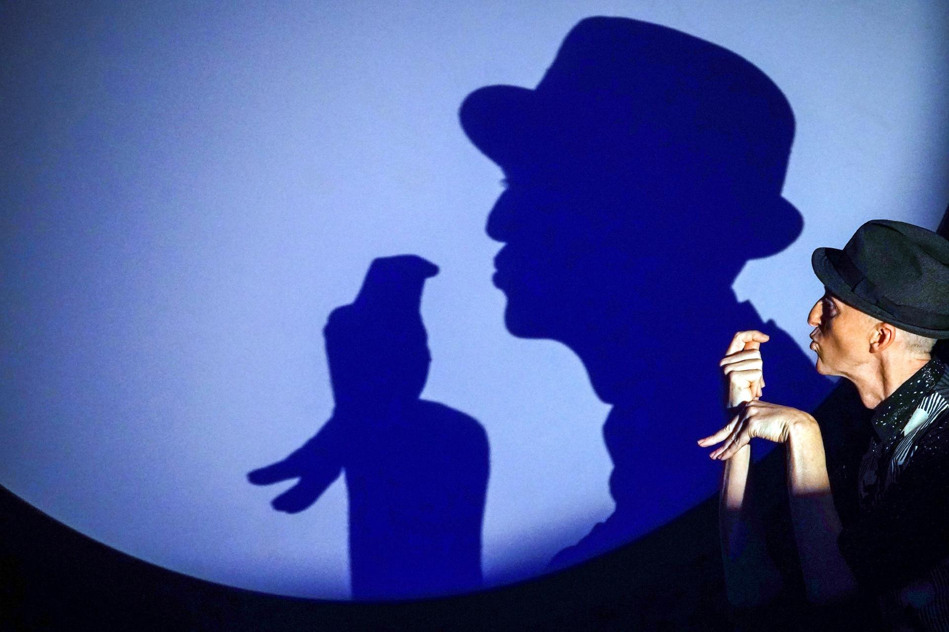 Silhouette of a man performing a magic trick