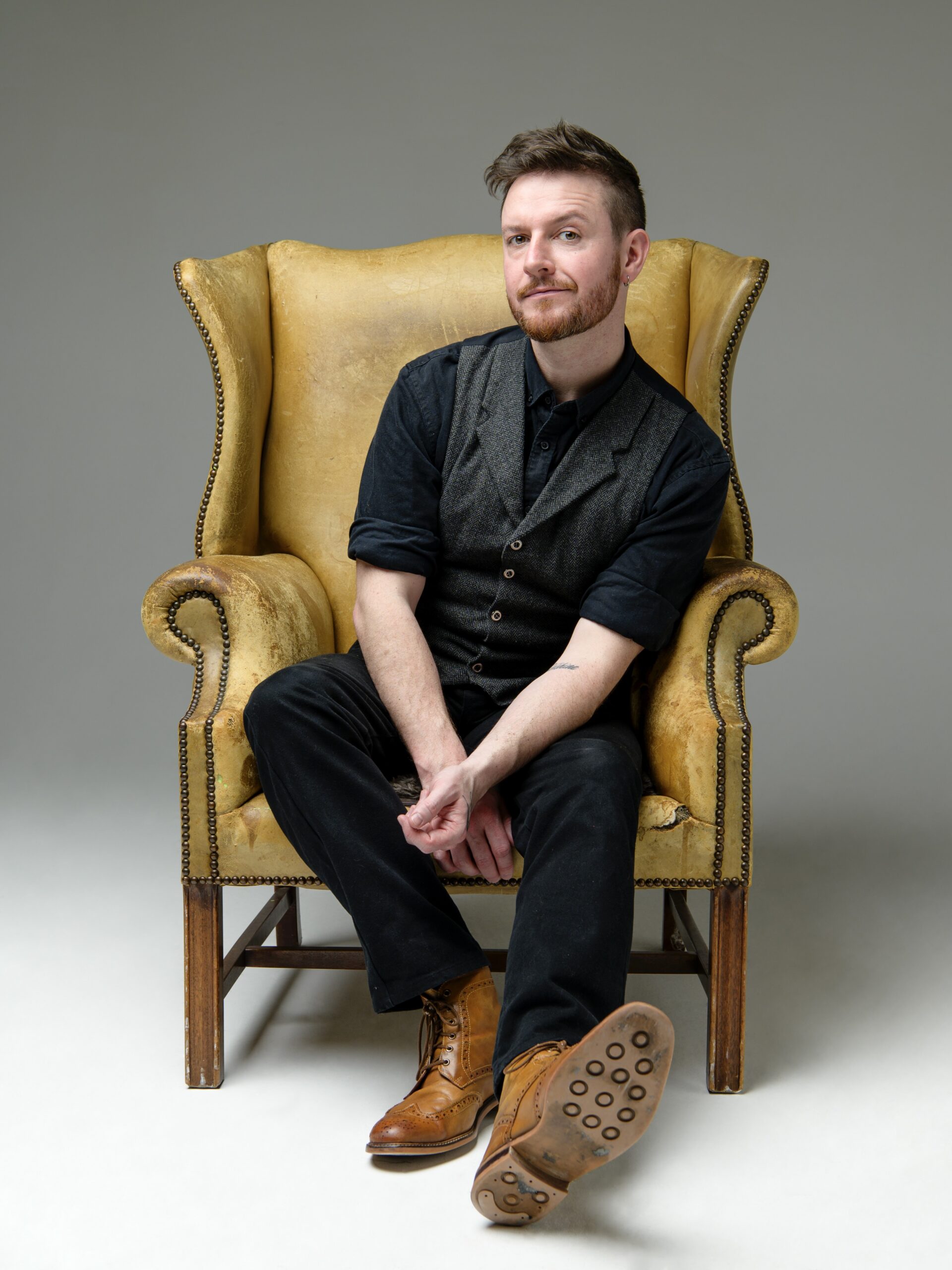Mentalist Alex McAleer sitting in a chair