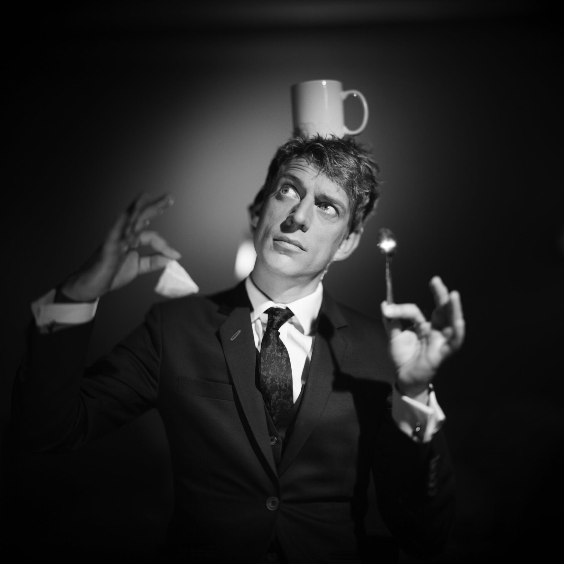 juggler jon udry balancing a teacup on his head
