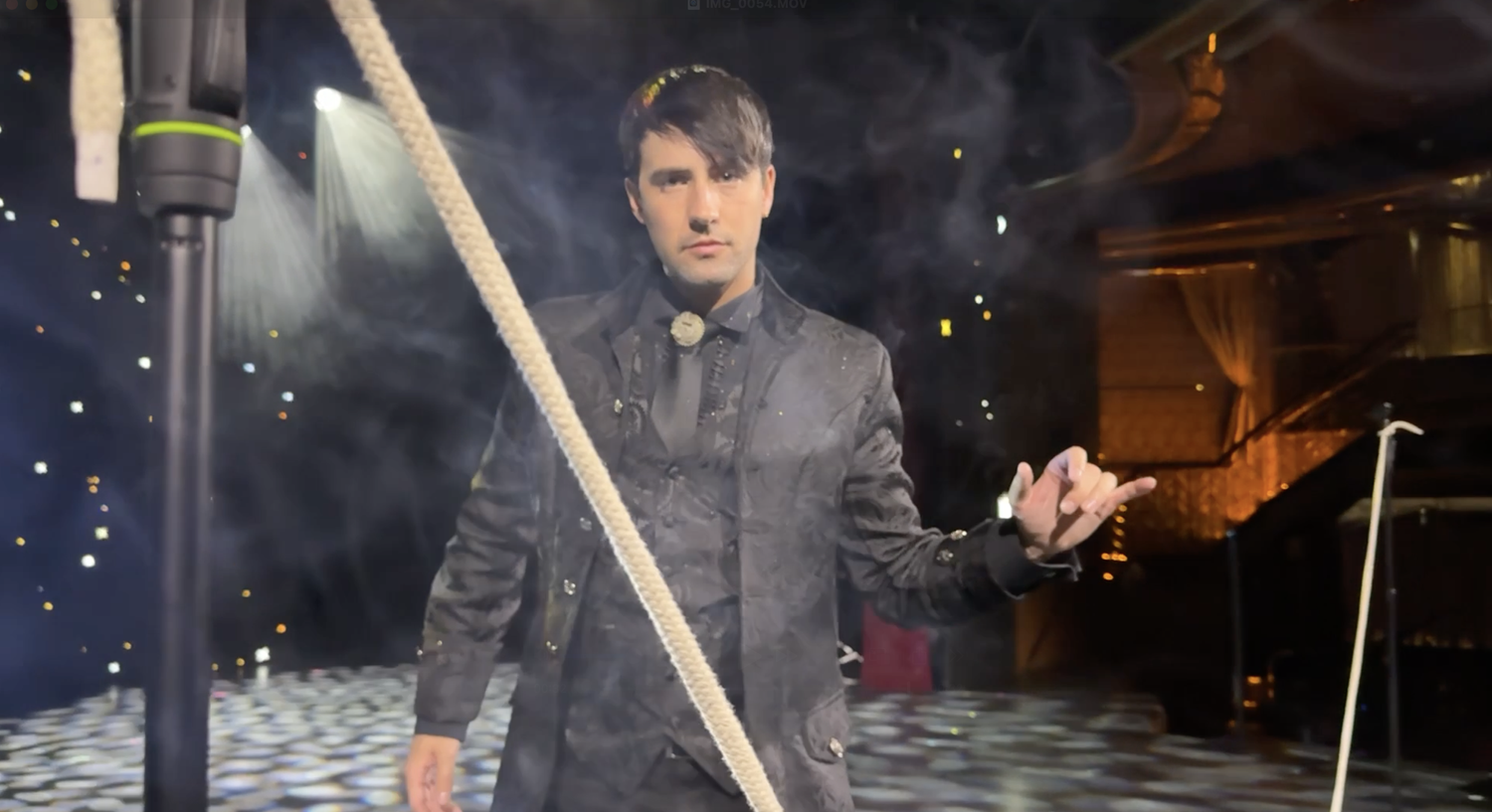 magician standing behind a length of rope