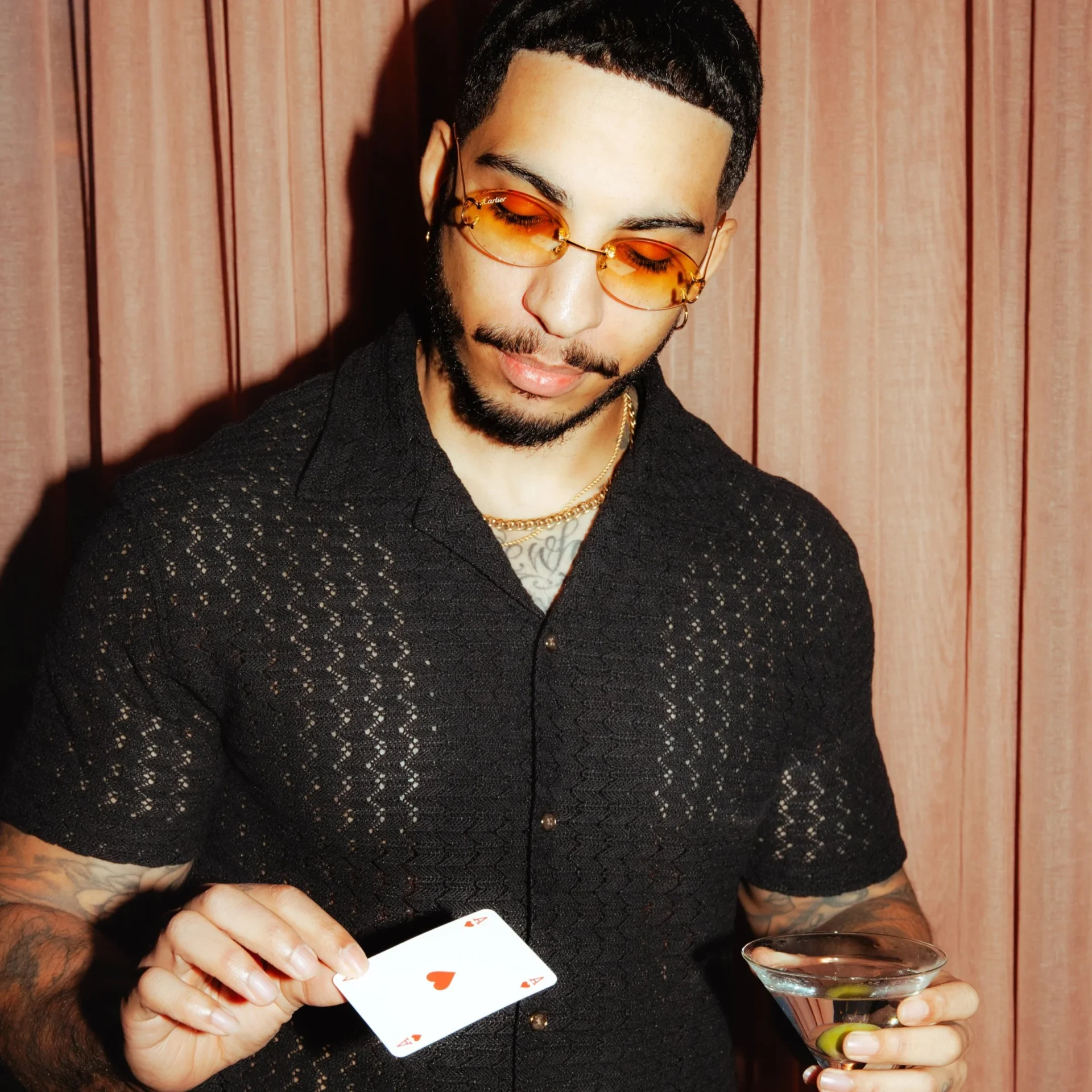 Troy holding a single playing card